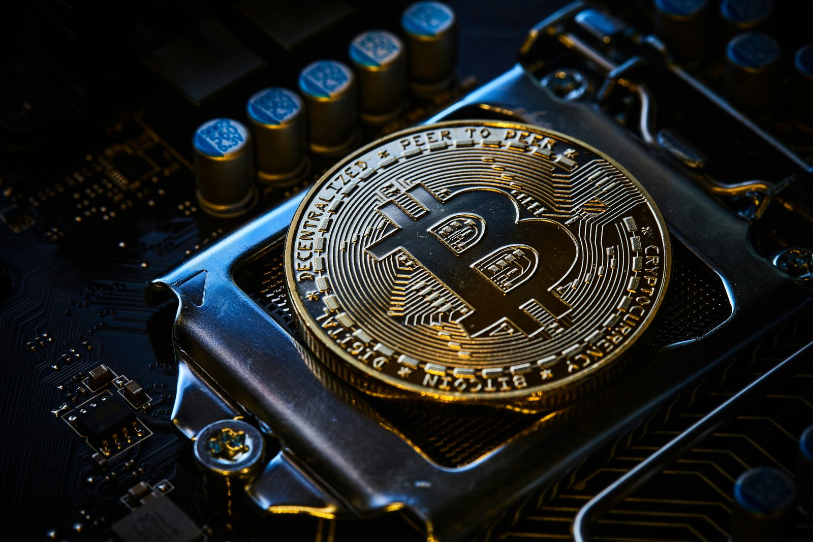 Bitcoin coin resting on a computer motherboard